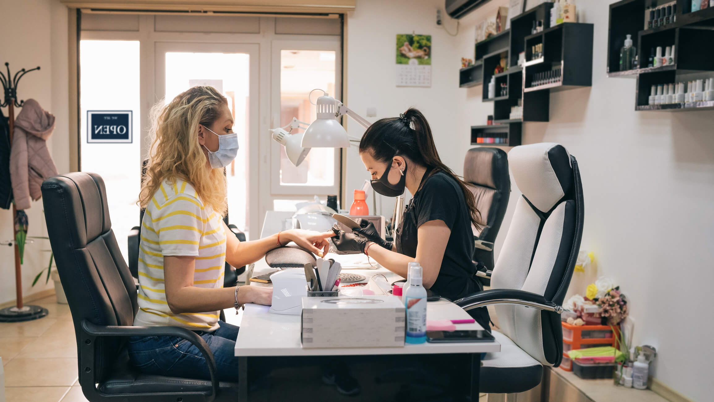 woman getting her nails done at a salon during the covid pandemic