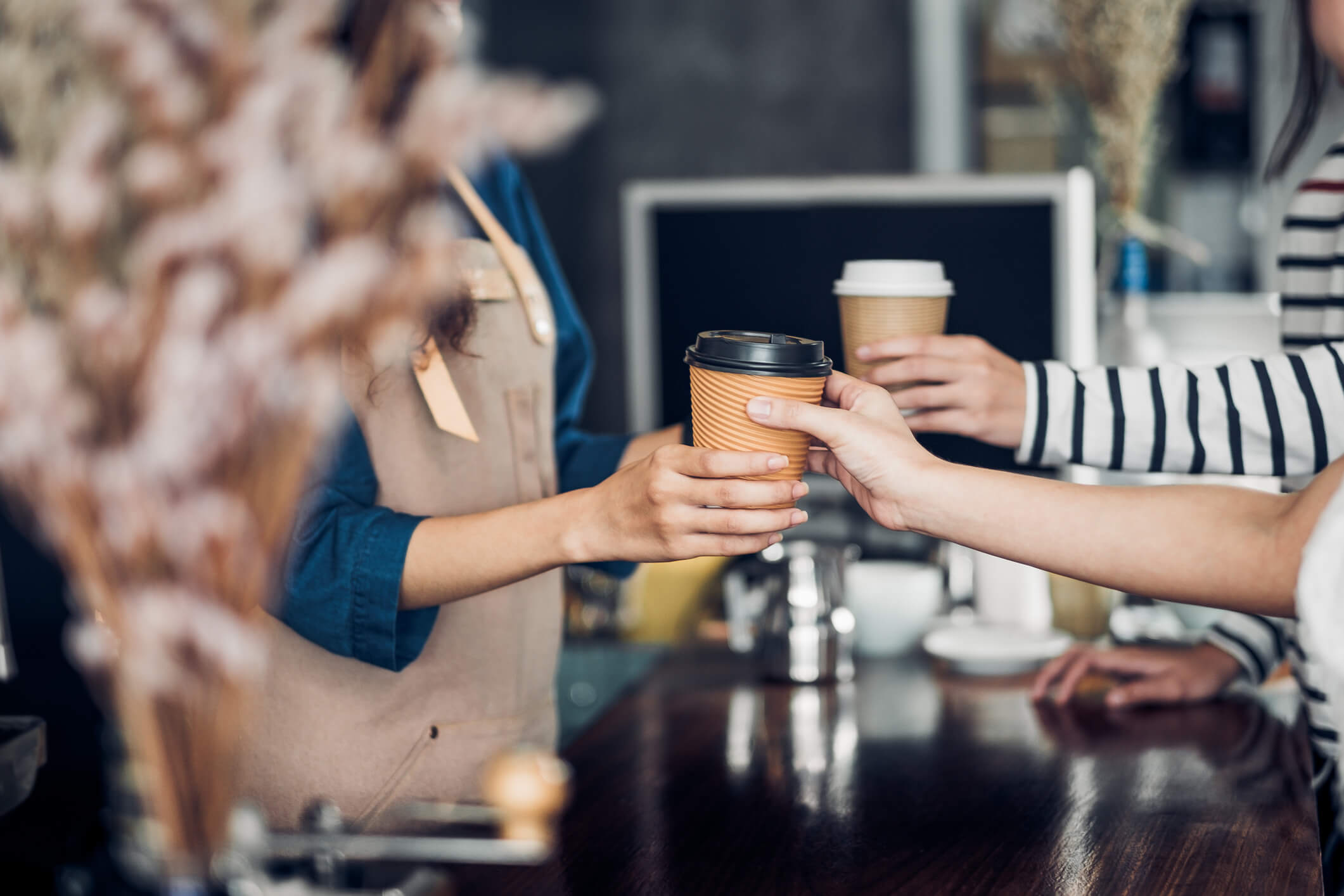 barista giving customer their coffee