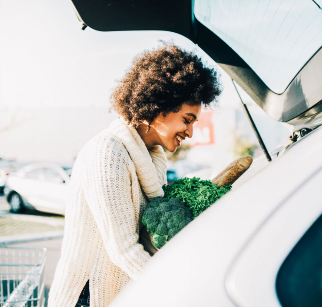 Woman Putting Groceries in Her Car